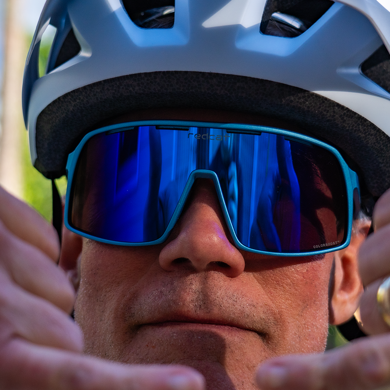 Mountain biker wearing Redcat™ Eyewear BEAST™ with CarbonGlo™ with Blue Blaze™ Mirror lenses.